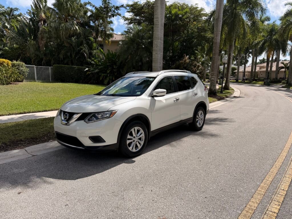A white Nissan Rogue is parked in a South Florida suburb.